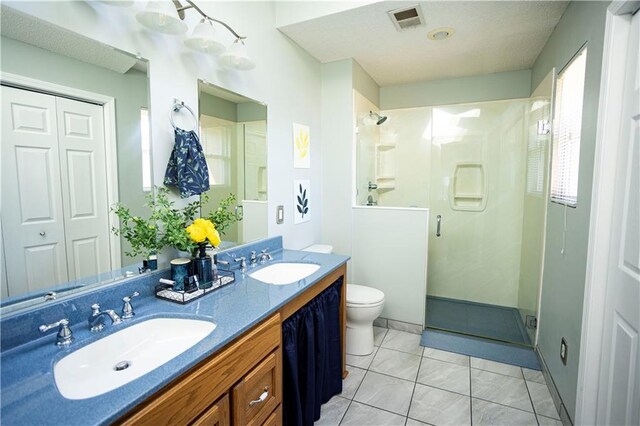 full bath featuring toilet, a stall shower, visible vents, and a sink