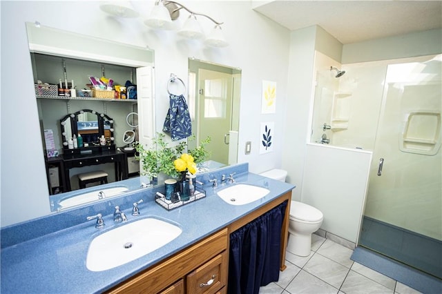 full bathroom featuring a stall shower, tile patterned flooring, a sink, and toilet