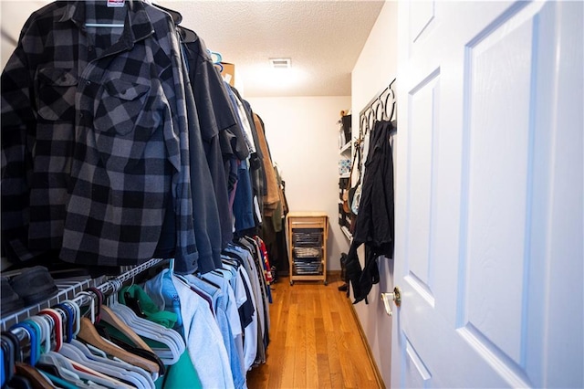 spacious closet with light wood-type flooring and visible vents