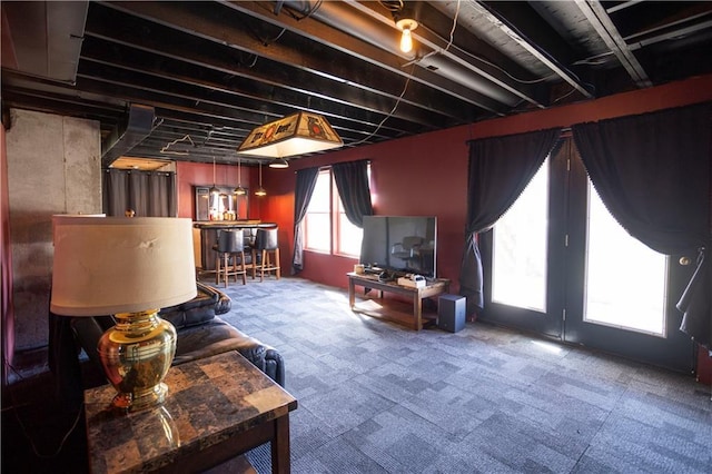 living area with carpet floors and a bar