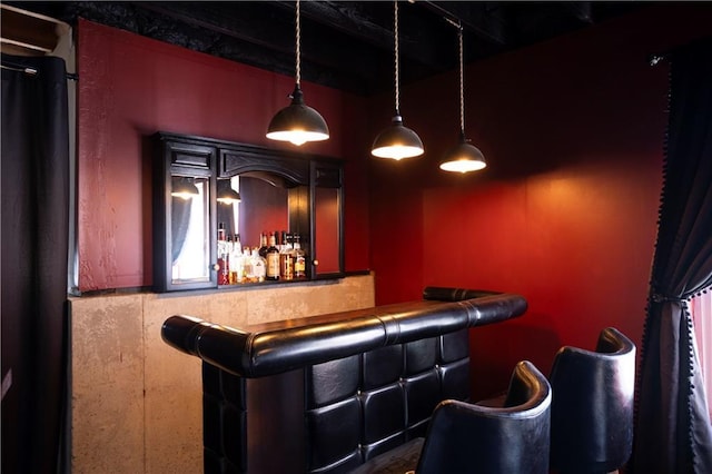 bar featuring decorative light fixtures, a dry bar, and black fridge