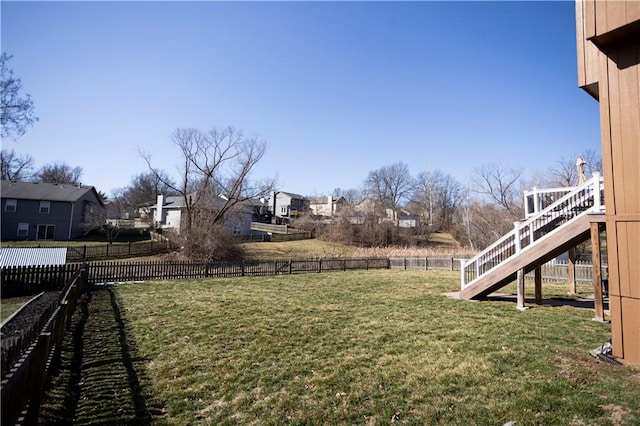 view of yard featuring a fenced backyard and stairway