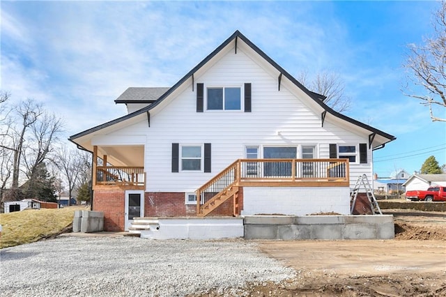 rear view of property featuring stairs