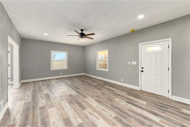 spare room featuring recessed lighting, ceiling fan, baseboards, and wood finished floors