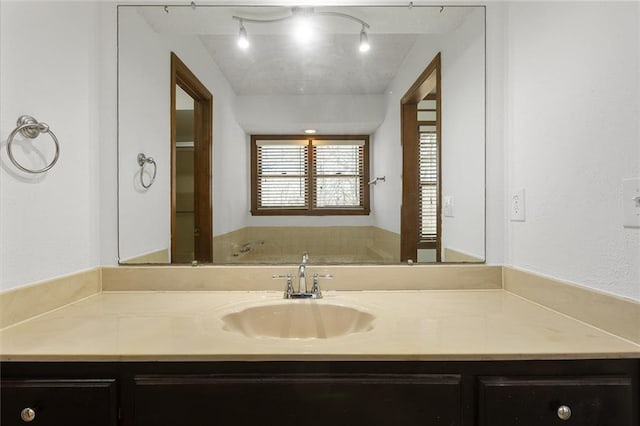 bathroom featuring vanity and rail lighting