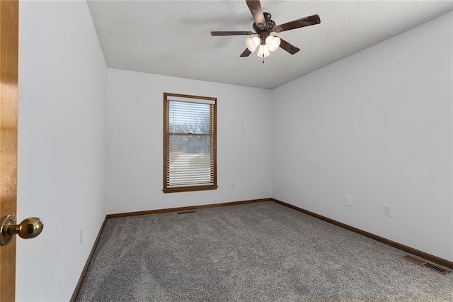 spare room featuring baseboards, visible vents, ceiling fan, a textured ceiling, and carpet flooring