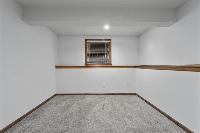 empty room with baseboards and carpet floors