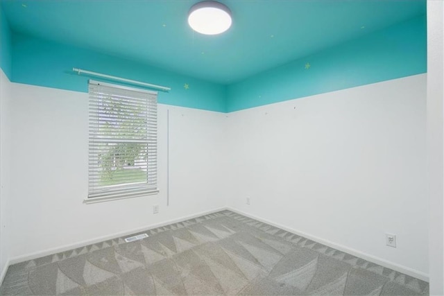 carpeted empty room with baseboards and visible vents