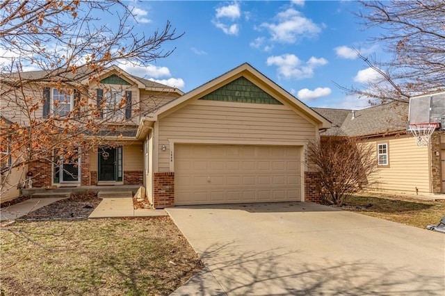 traditional-style home featuring concrete driveway, a garage, and brick siding