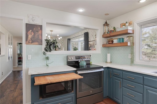 kitchen featuring electric range, blue cabinetry, a healthy amount of sunlight, and black microwave