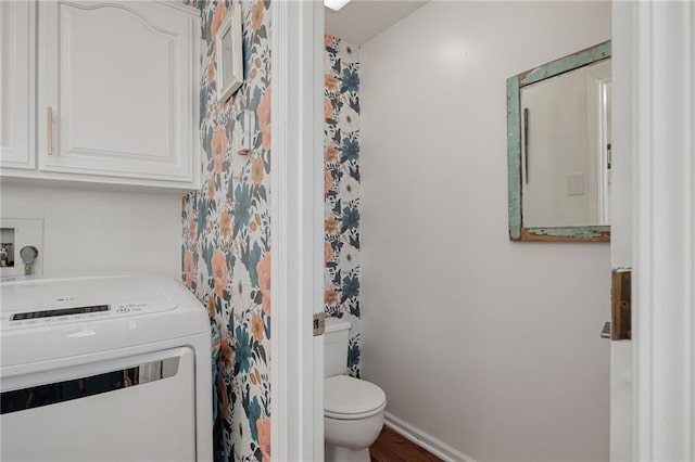 bathroom with baseboards, washer / clothes dryer, and toilet