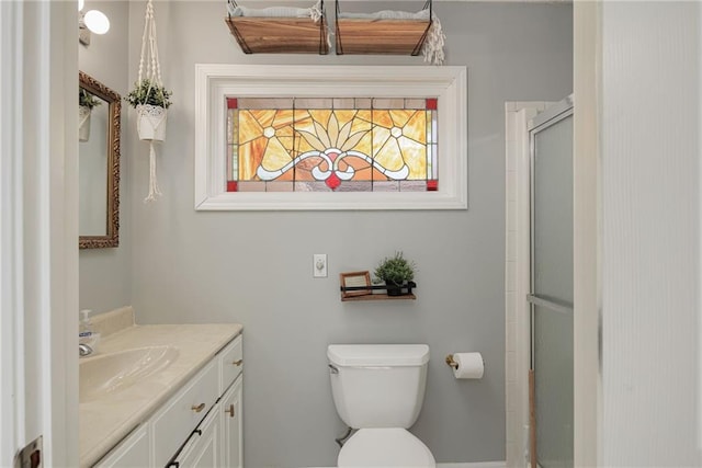 full bathroom featuring an enclosed shower, toilet, and vanity