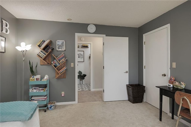 carpeted bedroom with baseboards and a textured ceiling