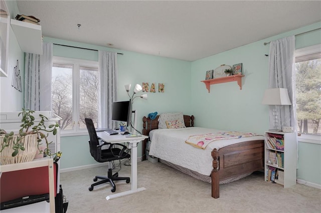 carpeted bedroom with baseboards