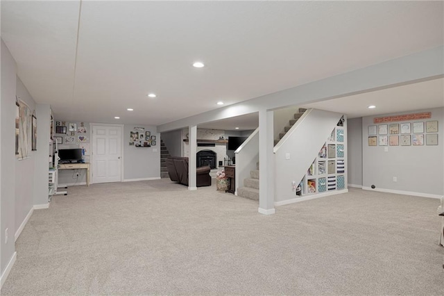 finished basement featuring recessed lighting, baseboards, light carpet, and stairs