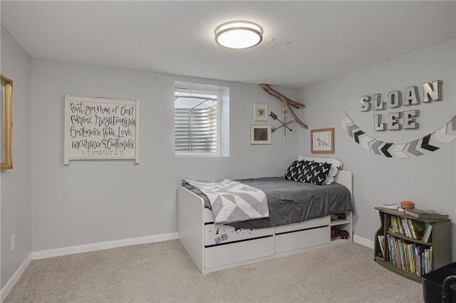 carpeted bedroom featuring baseboards