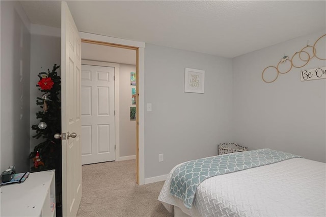 bedroom featuring baseboards, carpet floors, and a textured ceiling