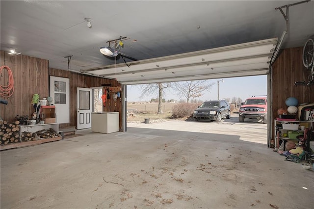 garage featuring wooden walls and a garage door opener