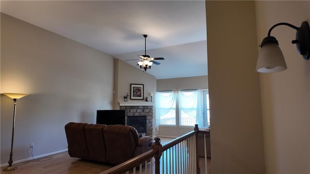 interior space featuring baseboards, lofted ceiling, and wood finished floors