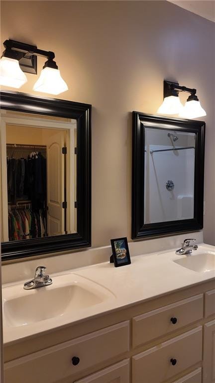 bathroom featuring a sink and double vanity