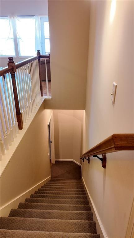 staircase with carpet flooring and baseboards