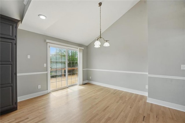 12203 E 214th Ter, Peculiar, MO 64078 - unfurnished dining area featuring a chandelier, vaulted ceiling, light wood-style flooring, and baseboards