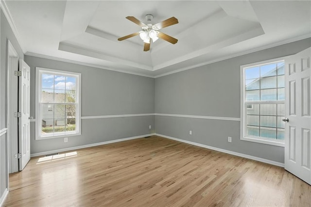 12203 E 214th Ter, Peculiar, MO 64078 - spare room featuring a tray ceiling, light wood-style flooring, ceiling fan, ornamental molding, and baseboards