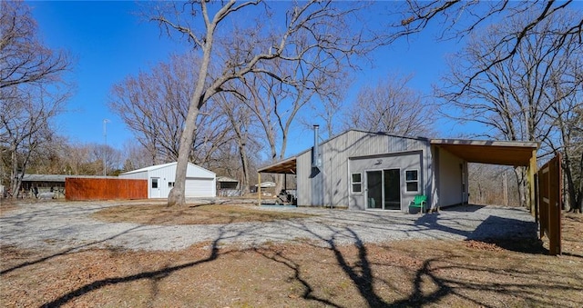 rear view of property with an outbuilding