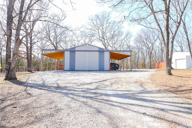 garage featuring driveway and a detached garage