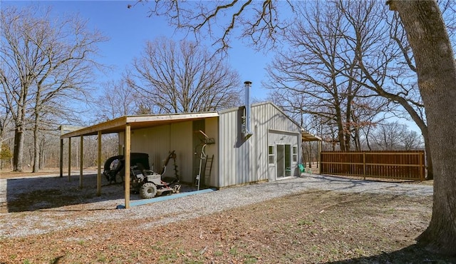 view of outbuilding with fence and an outdoor structure