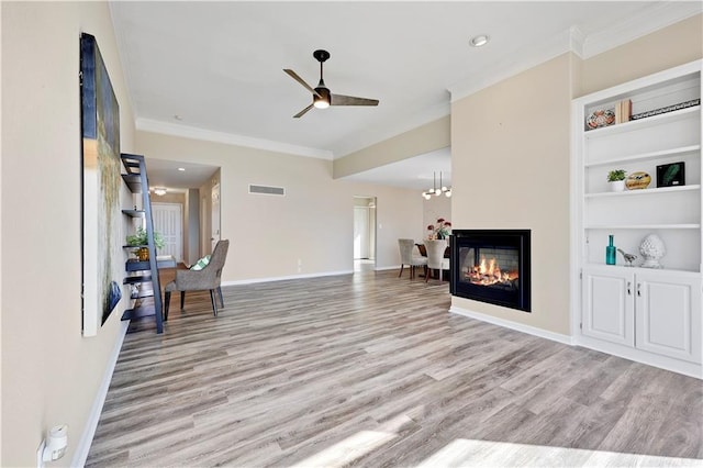 living area featuring baseboards, wood finished floors, a multi sided fireplace, and ornamental molding