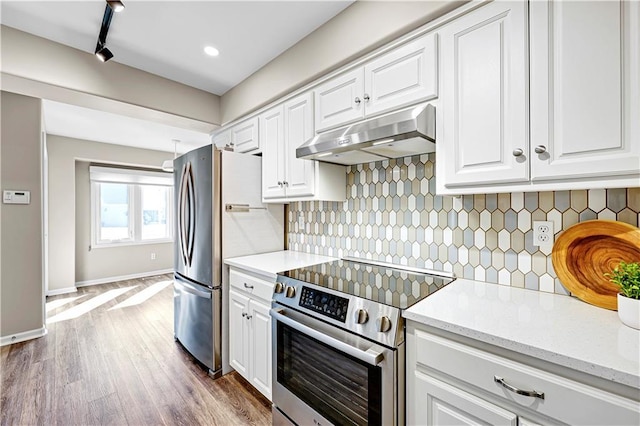 kitchen with under cabinet range hood, appliances with stainless steel finishes, and white cabinetry