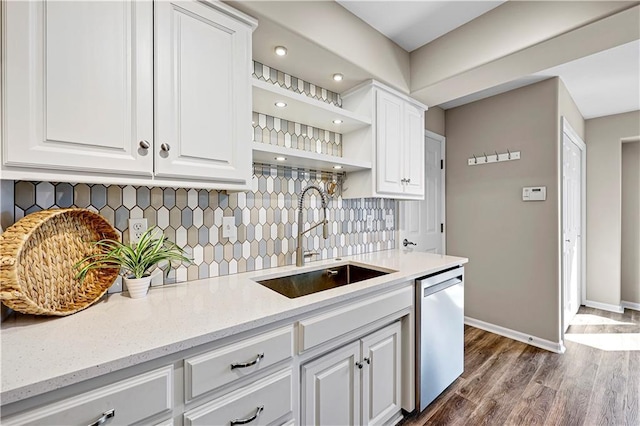 kitchen featuring white cabinets, open shelves, stainless steel dishwasher, and a sink