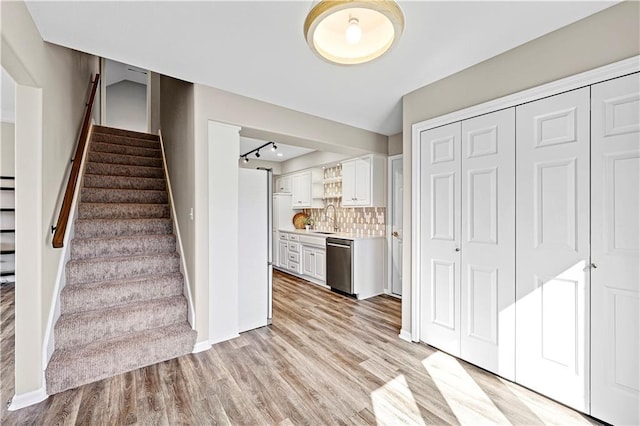 stairs with baseboards and wood finished floors