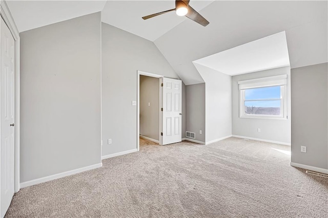 additional living space featuring visible vents, baseboards, ceiling fan, lofted ceiling, and carpet flooring