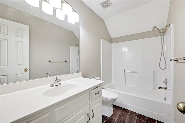 full bathroom with vanity, visible vents, wood finish floors, vaulted ceiling, and toilet