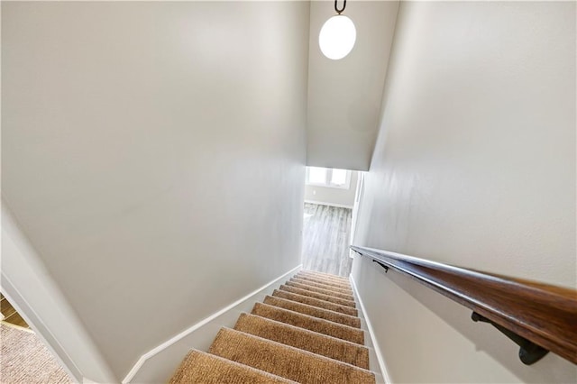 stairs featuring baseboards and wood finished floors