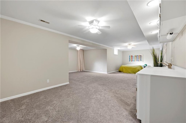 interior space featuring visible vents, carpet floors, crown molding, baseboards, and ceiling fan