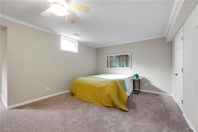 carpeted bedroom featuring ceiling fan, visible vents, baseboards, and ornamental molding