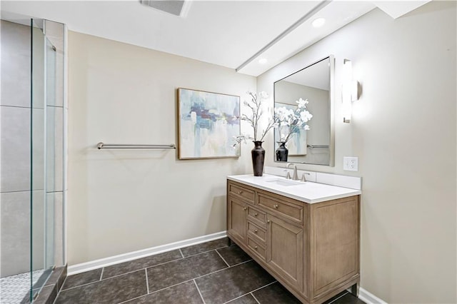 full bath featuring vanity, a shower with shower door, baseboards, and visible vents