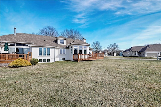 back of house with a chimney, a wooden deck, and a yard