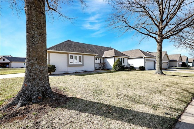 ranch-style house featuring a residential view, a front lawn, roof with shingles, and an attached garage