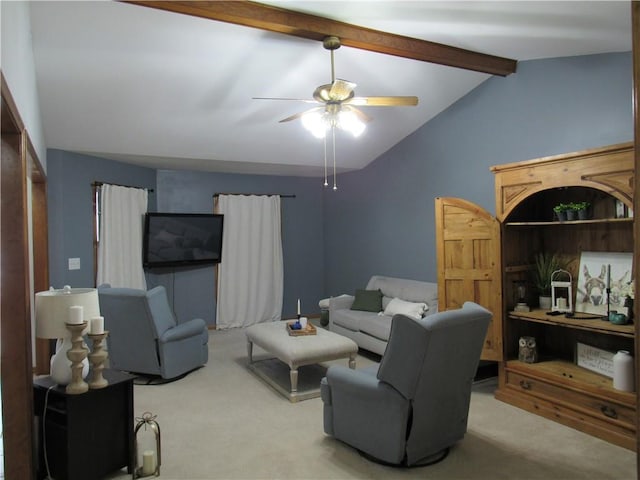 carpeted living area with ceiling fan and vaulted ceiling with beams