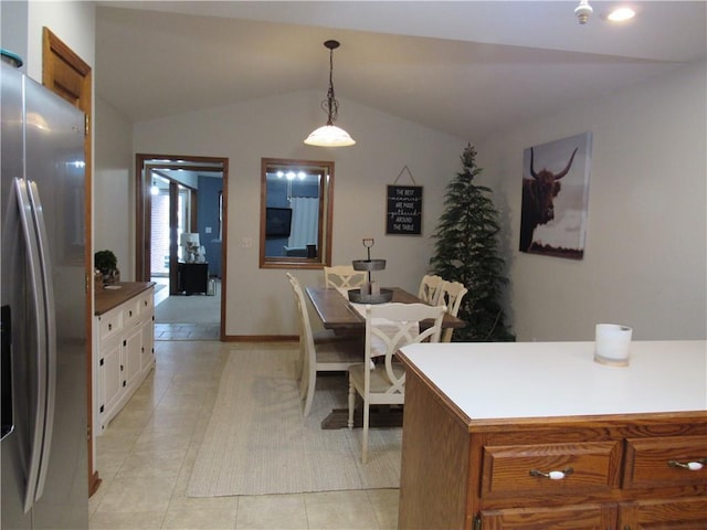 interior space featuring vaulted ceiling and light tile patterned floors