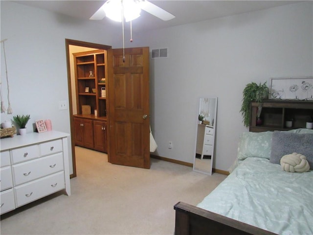 bedroom featuring visible vents, baseboards, light colored carpet, and ceiling fan