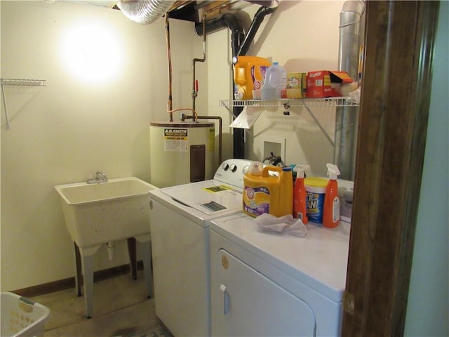 clothes washing area featuring washing machine and clothes dryer, laundry area, and electric water heater