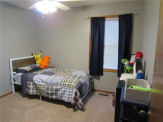 carpeted bedroom with baseboards and visible vents