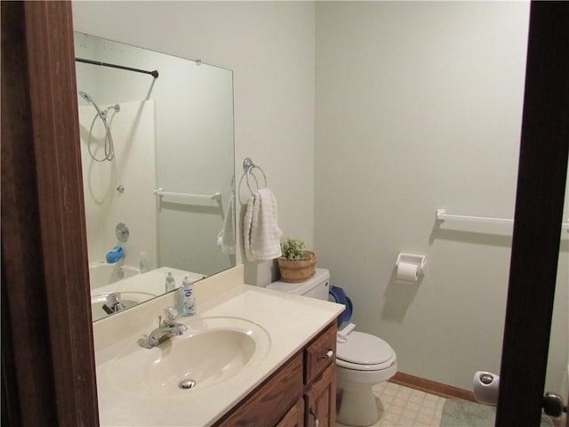 bathroom with baseboards, toilet, shower / tub combination, tile patterned floors, and vanity