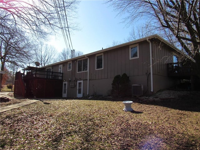 rear view of property featuring central AC unit and a deck