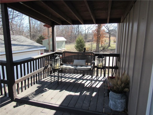 wooden deck with an outbuilding